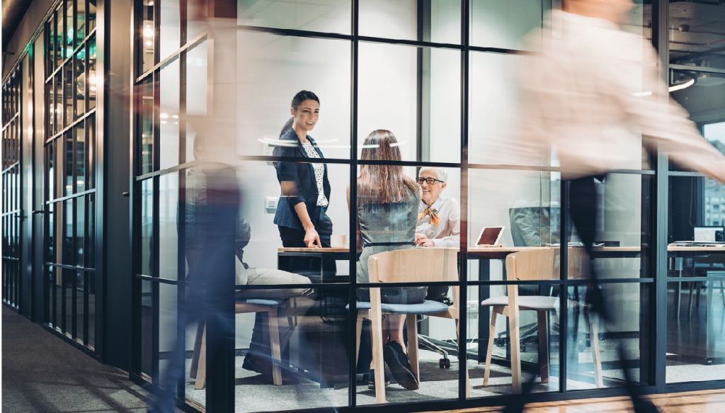 Office Conference Room with People Walking By